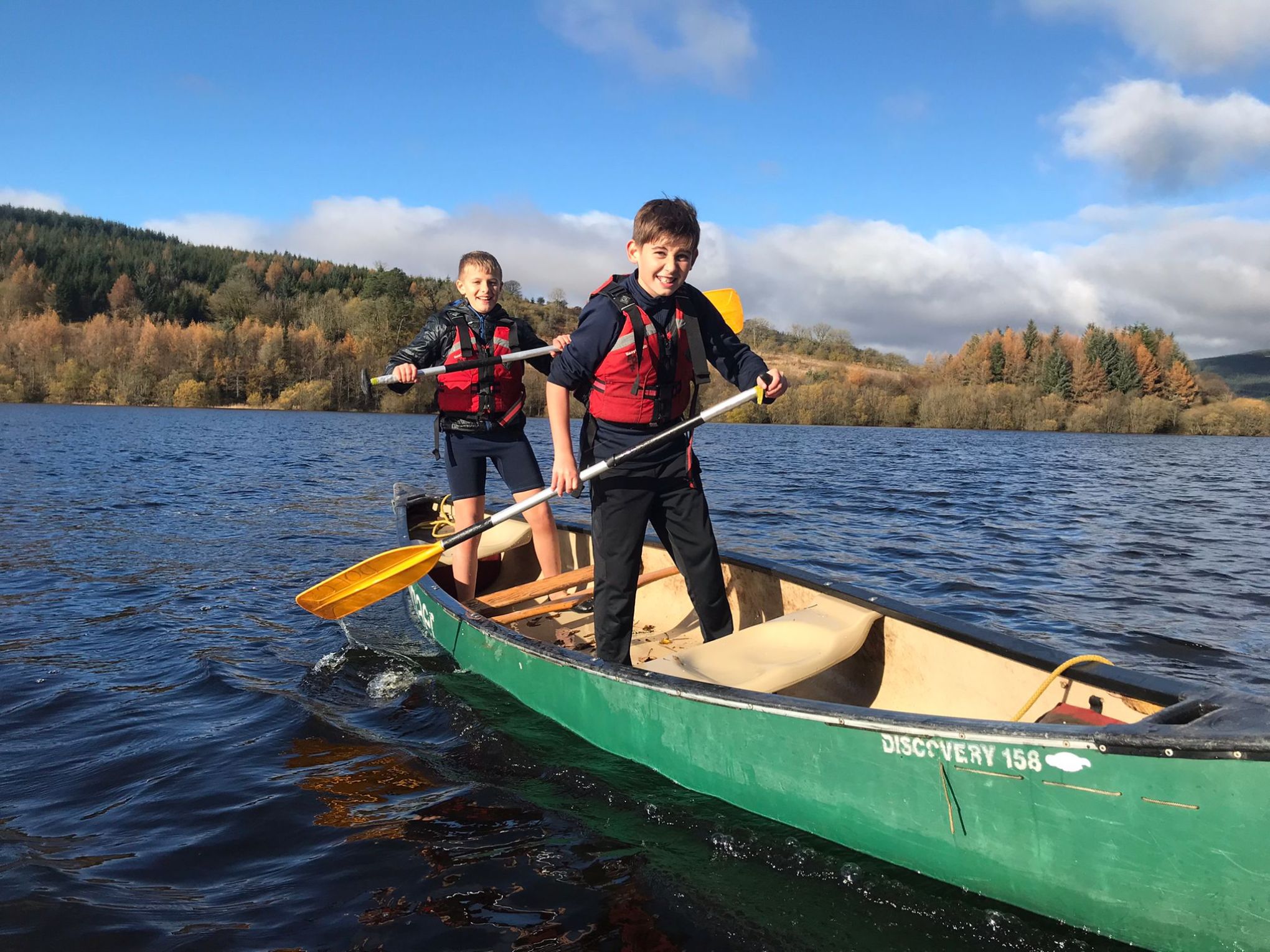 a person riding on the back of a boat in the water