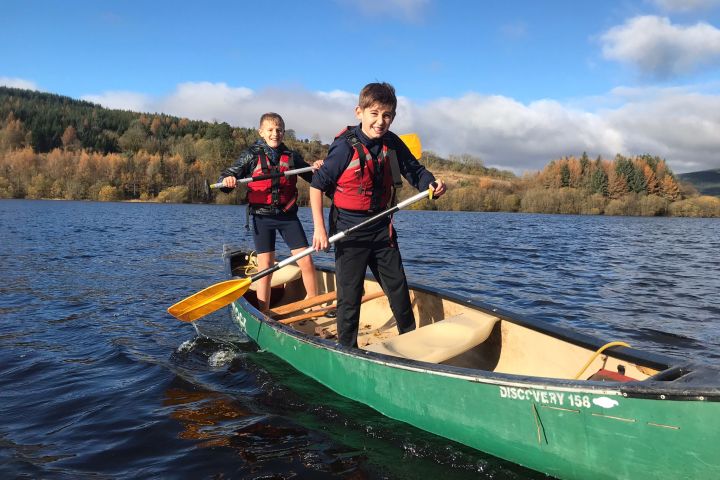 a person riding on the back of a boat in the water