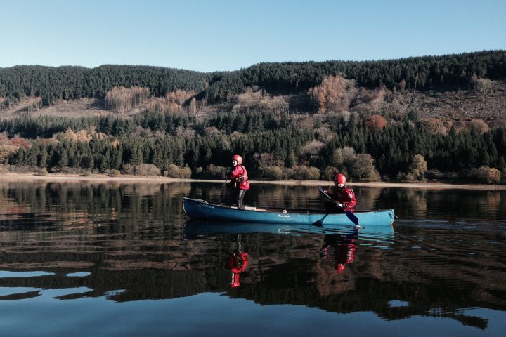 a group of people riding skis on a body of water