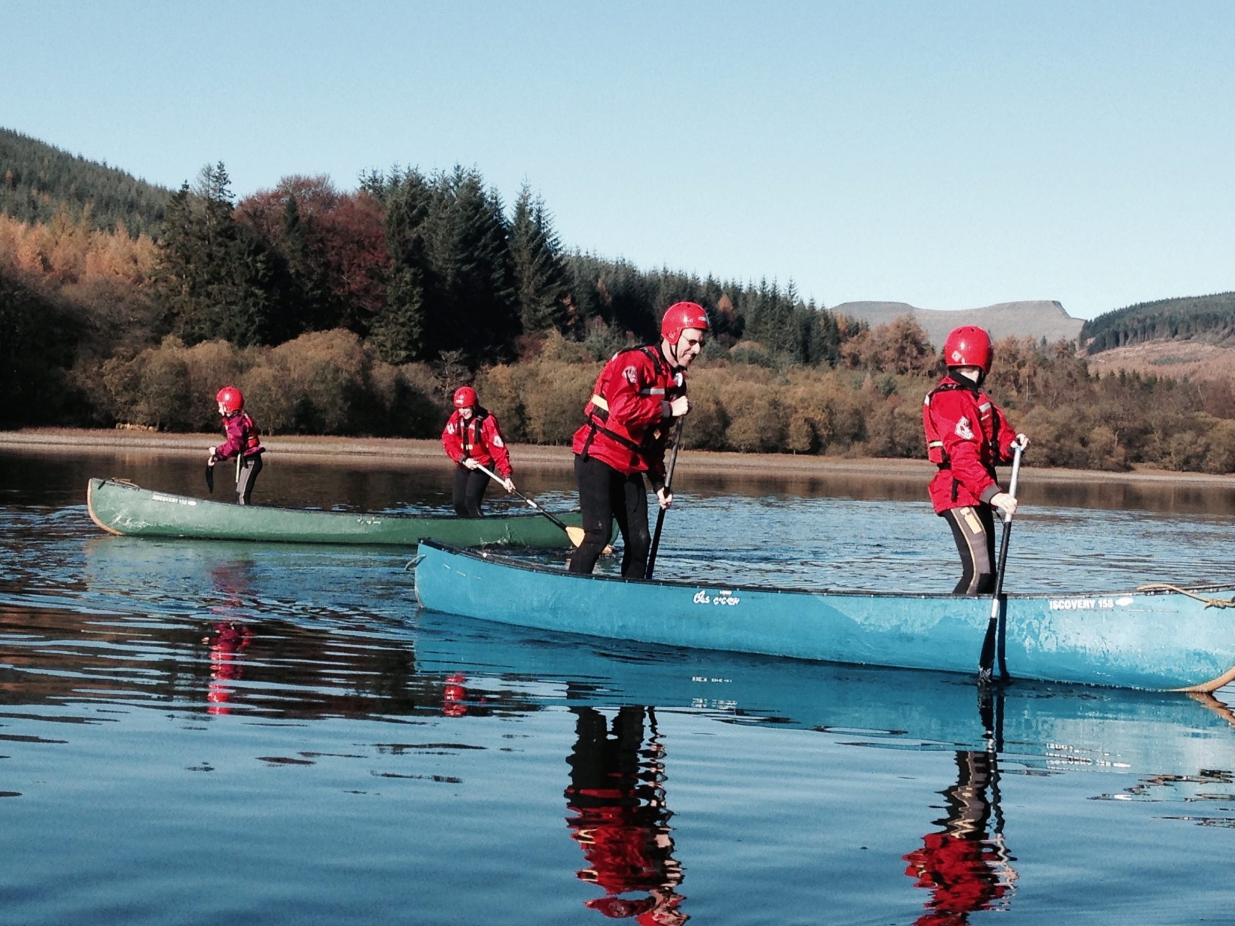 a group of people riding skis on a lake