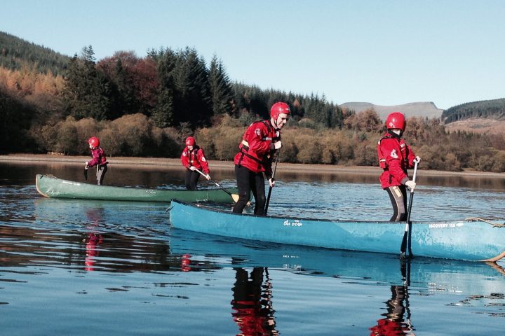 a group of people riding skis on a lake