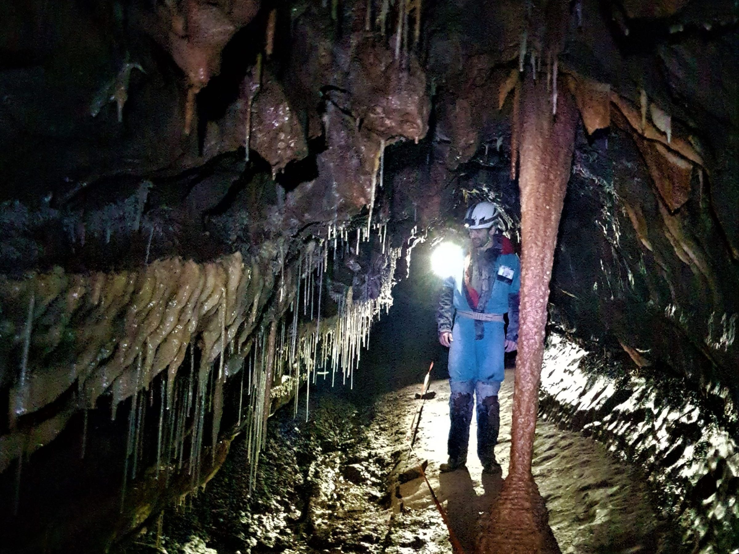 a man standing in front of a cave