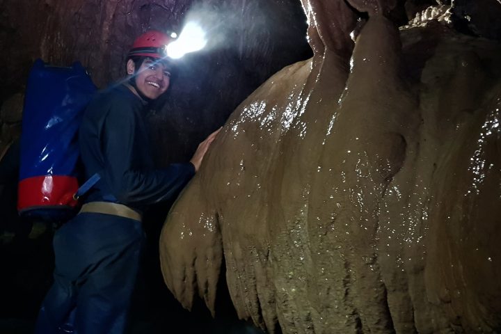 a man riding a elephant in the water