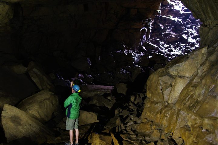 a young man in a cave