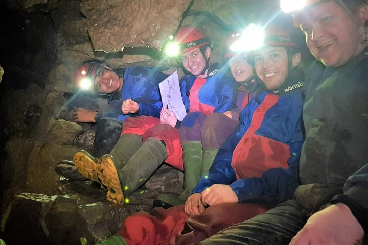 a group of people sitting around a fire