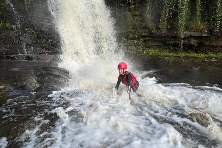 a man riding on the back of a waterfall