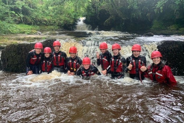 a group of people on a raft in a river
