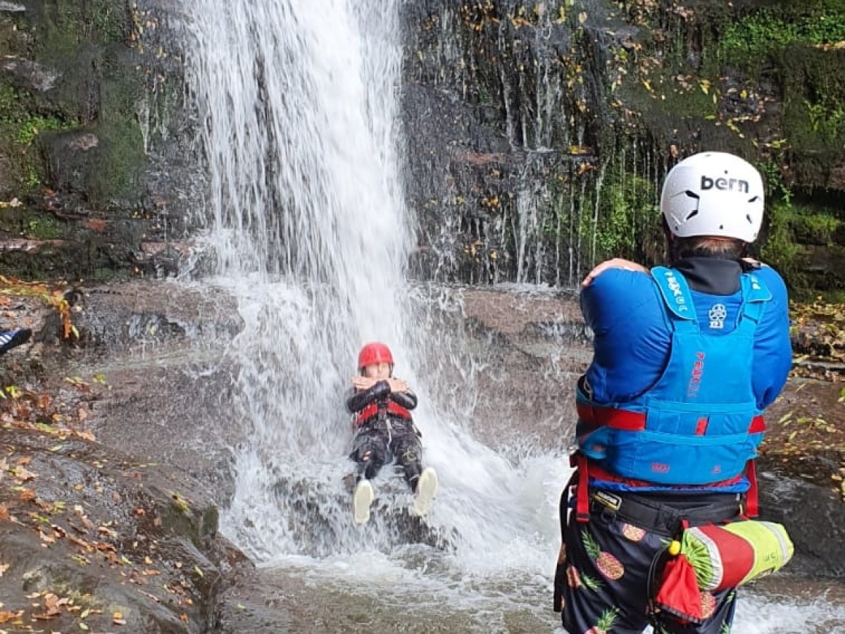 a group of people riding on the back of a waterfall
