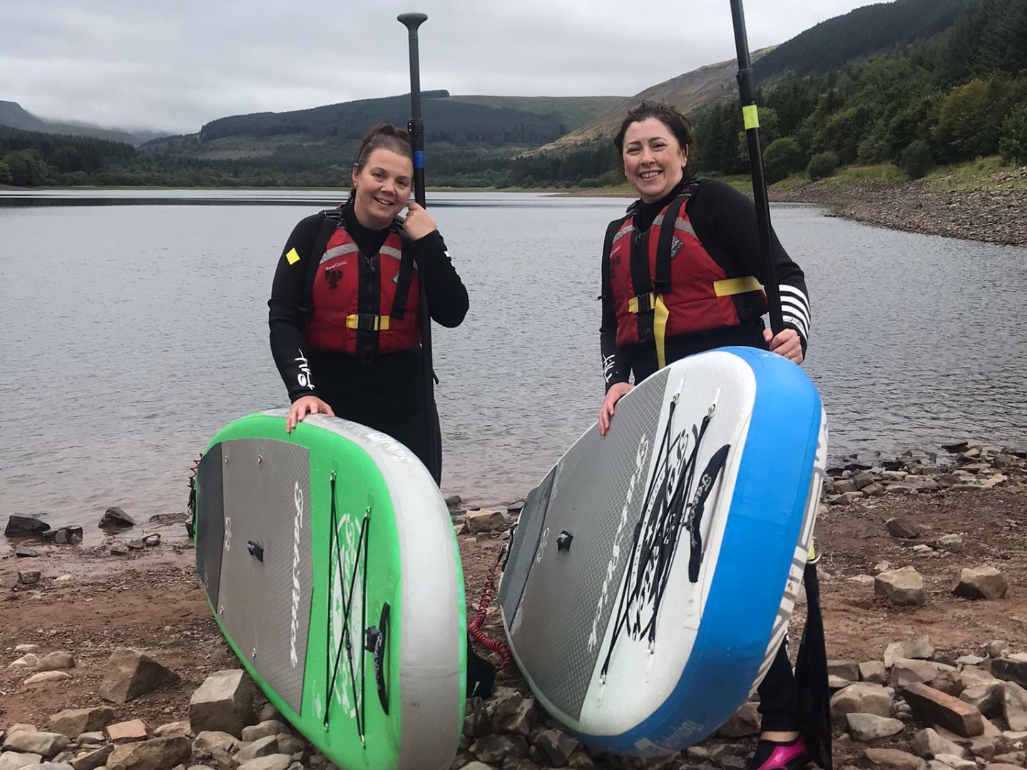 a group of people standing on a beach posing for the camera
