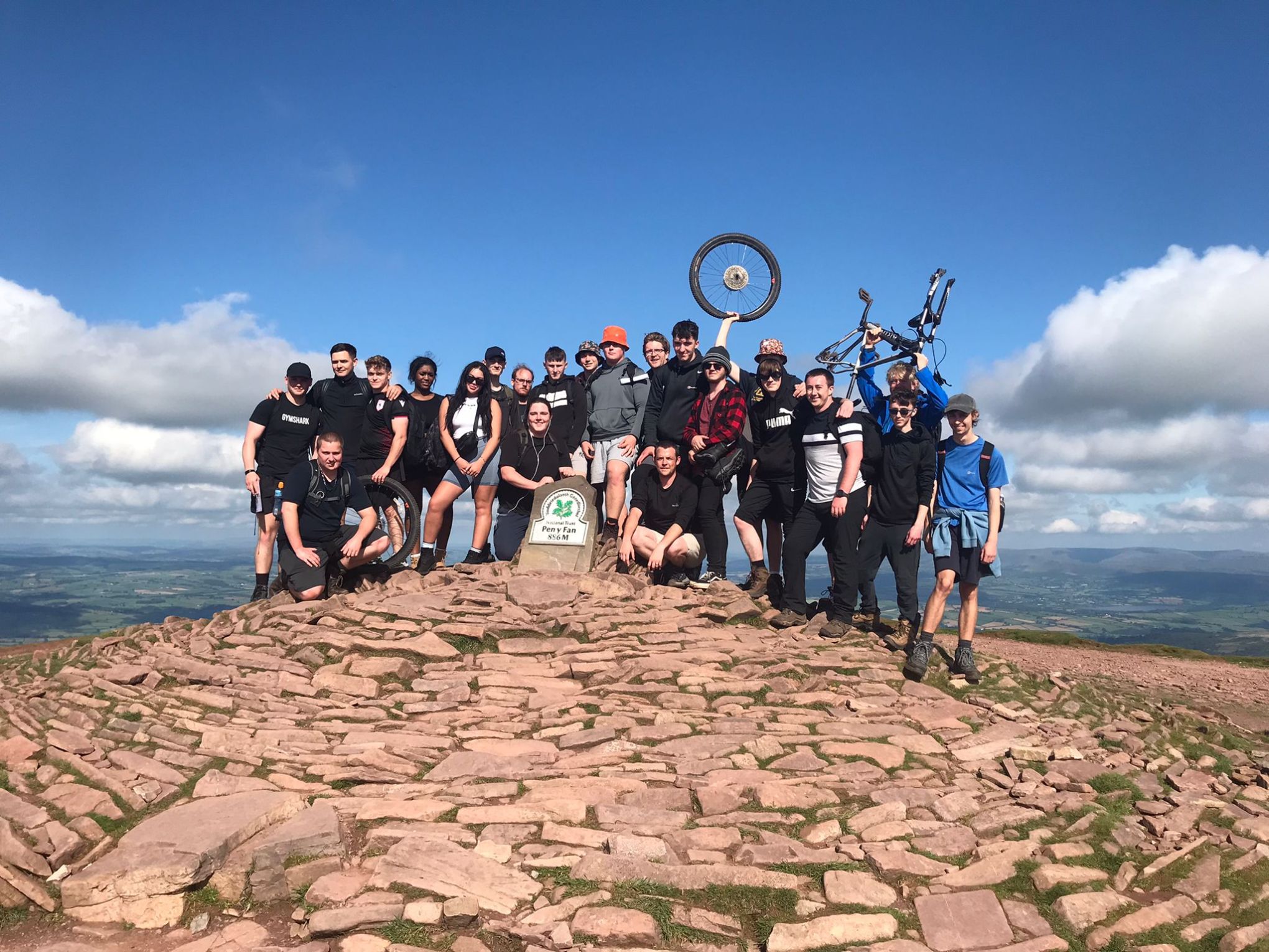 a group of people standing on top of a sandy beach