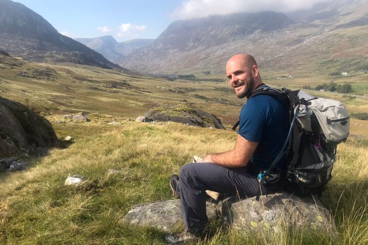a man sitting on top of a mountain