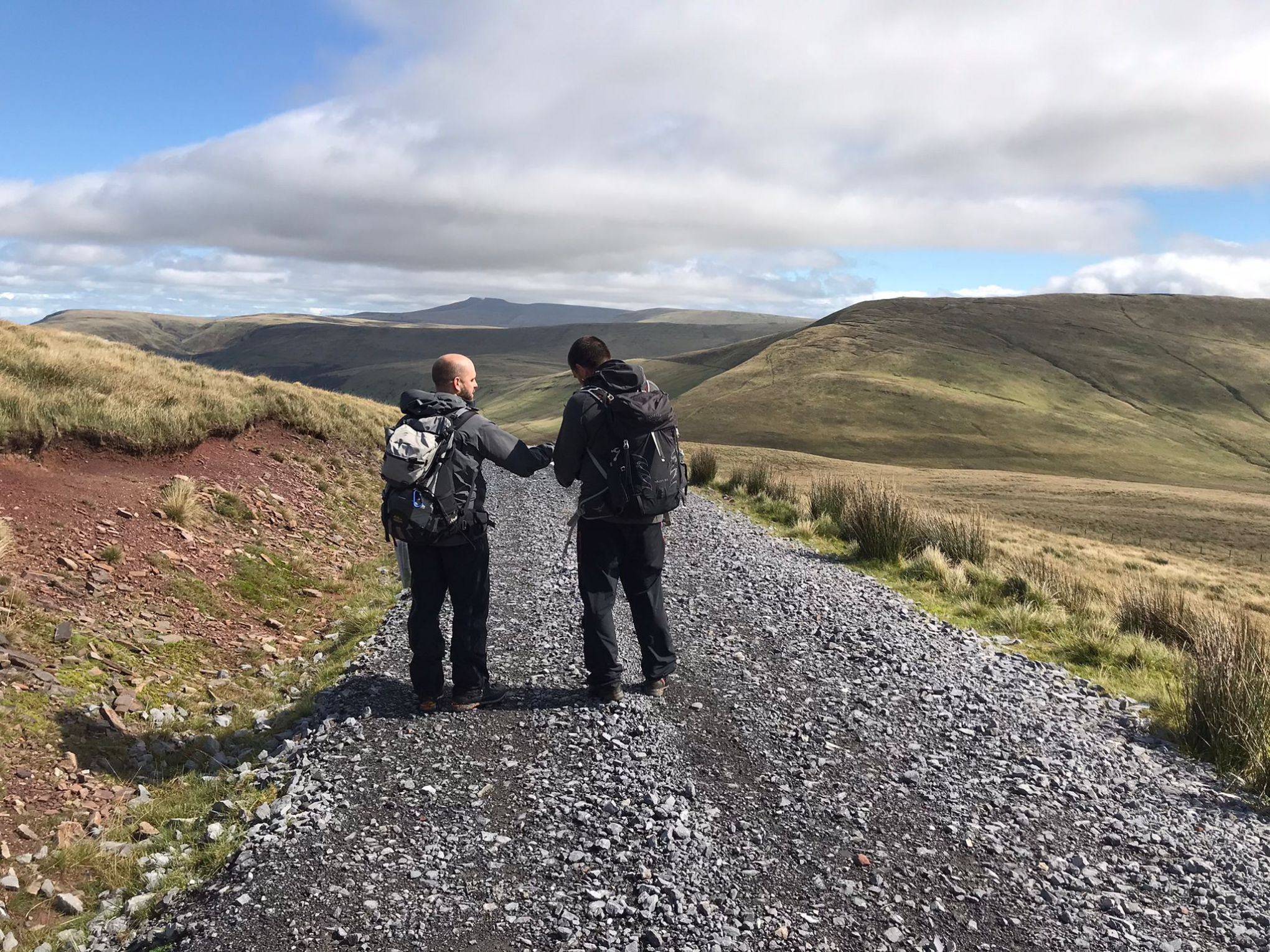 a man standing on a rocky hill