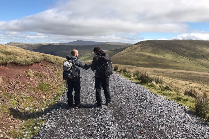 a man standing on a rocky hill