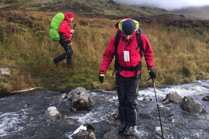 a man riding a bike down a dirt road