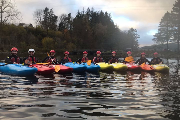a group of people riding on the back of a boat