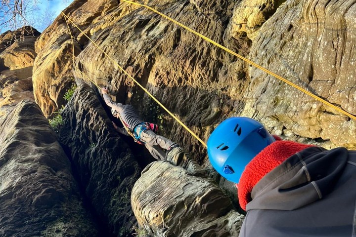 a person sitting on a rock