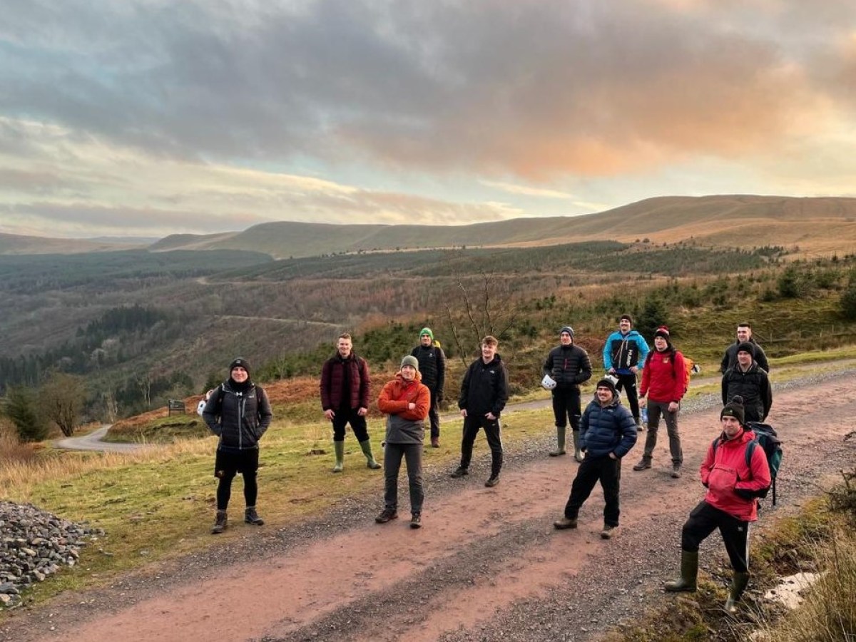 a group of people standing on top of a mountain