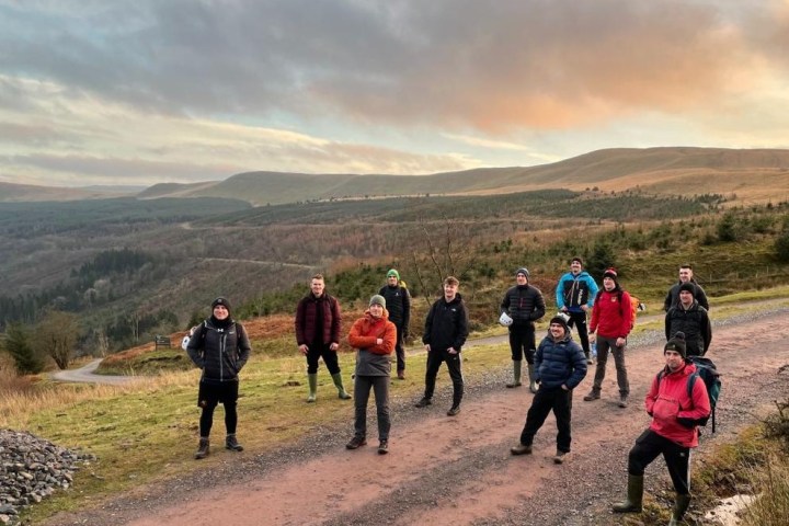 a group of people standing on top of a mountain