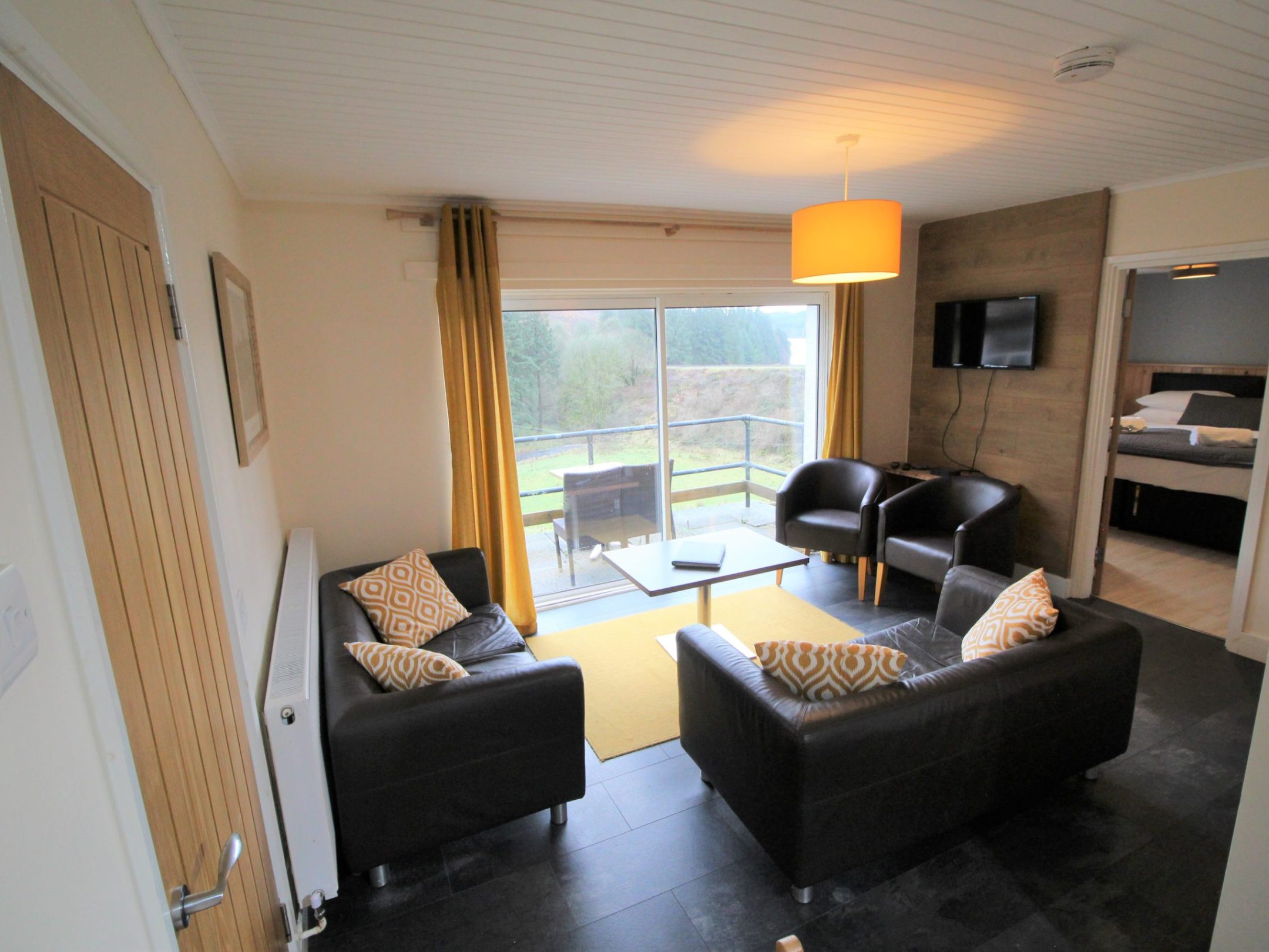 a living room filled with furniture and a large window