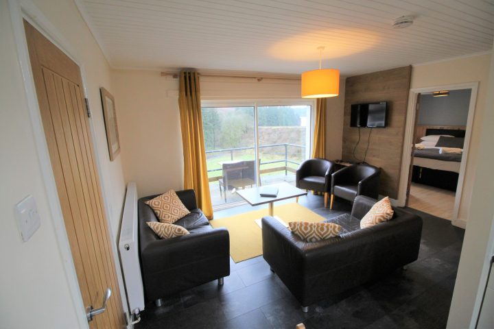 a living room filled with furniture and a large window