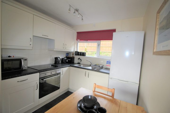 a stove top oven sitting inside of a kitchen