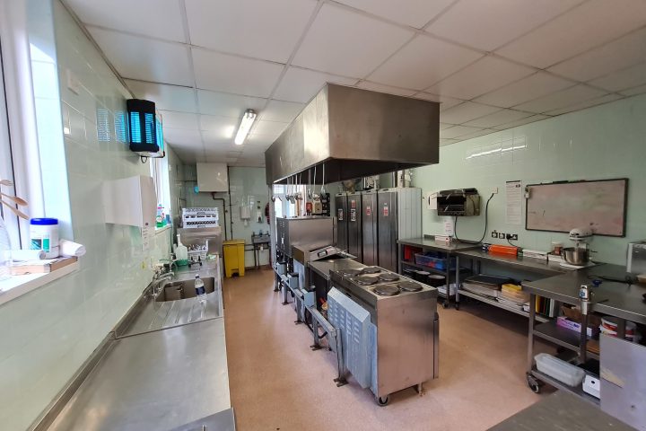 a group of people in a kitchen