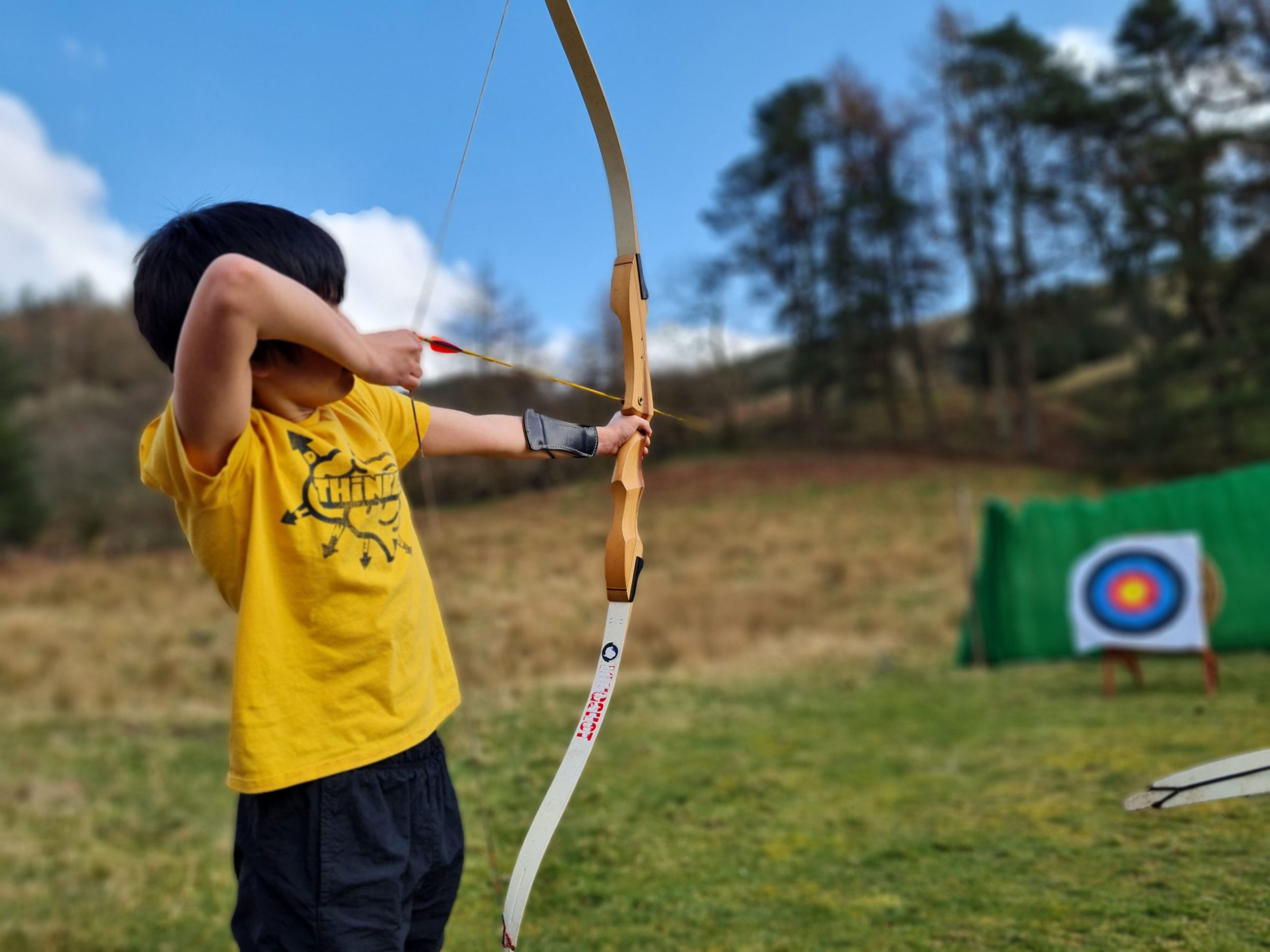 a young boy holding a baseball bat