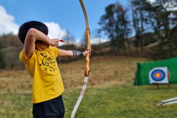 a young boy holding a baseball bat