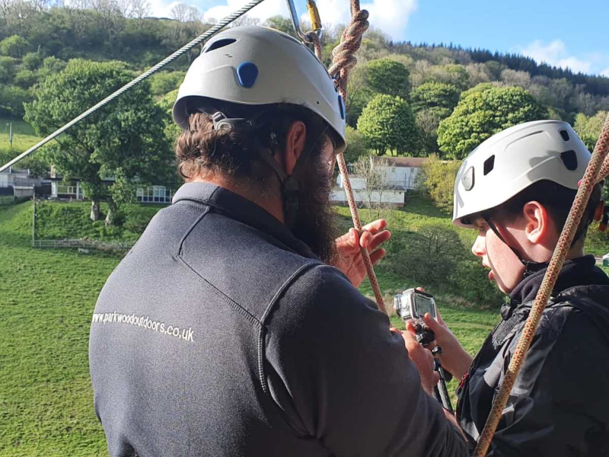 a man wearing a hat talking on a cell phone
