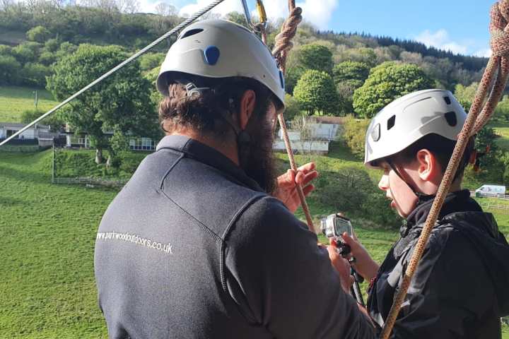 a man wearing a hat talking on a cell phone