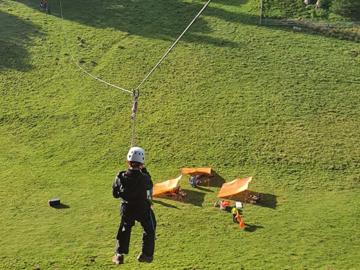 a man riding on top of a grass covered field