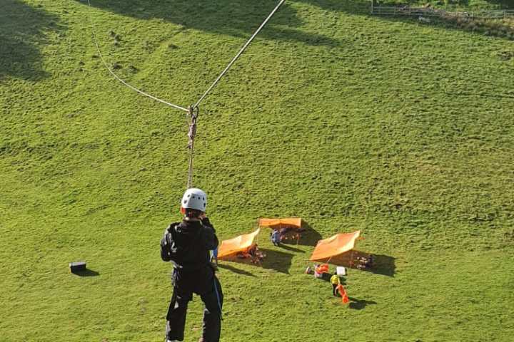 a man riding on top of a grass covered field