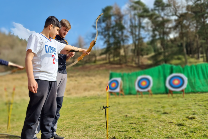 a person standing on top of a grass covered field