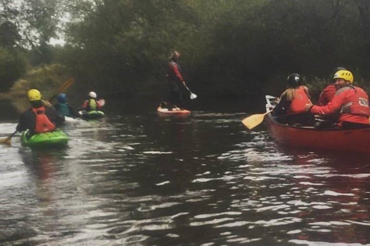 a group of people riding on the back of a boat