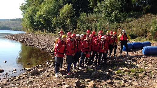 c17e-Stag-resize a group of people standing next to a river