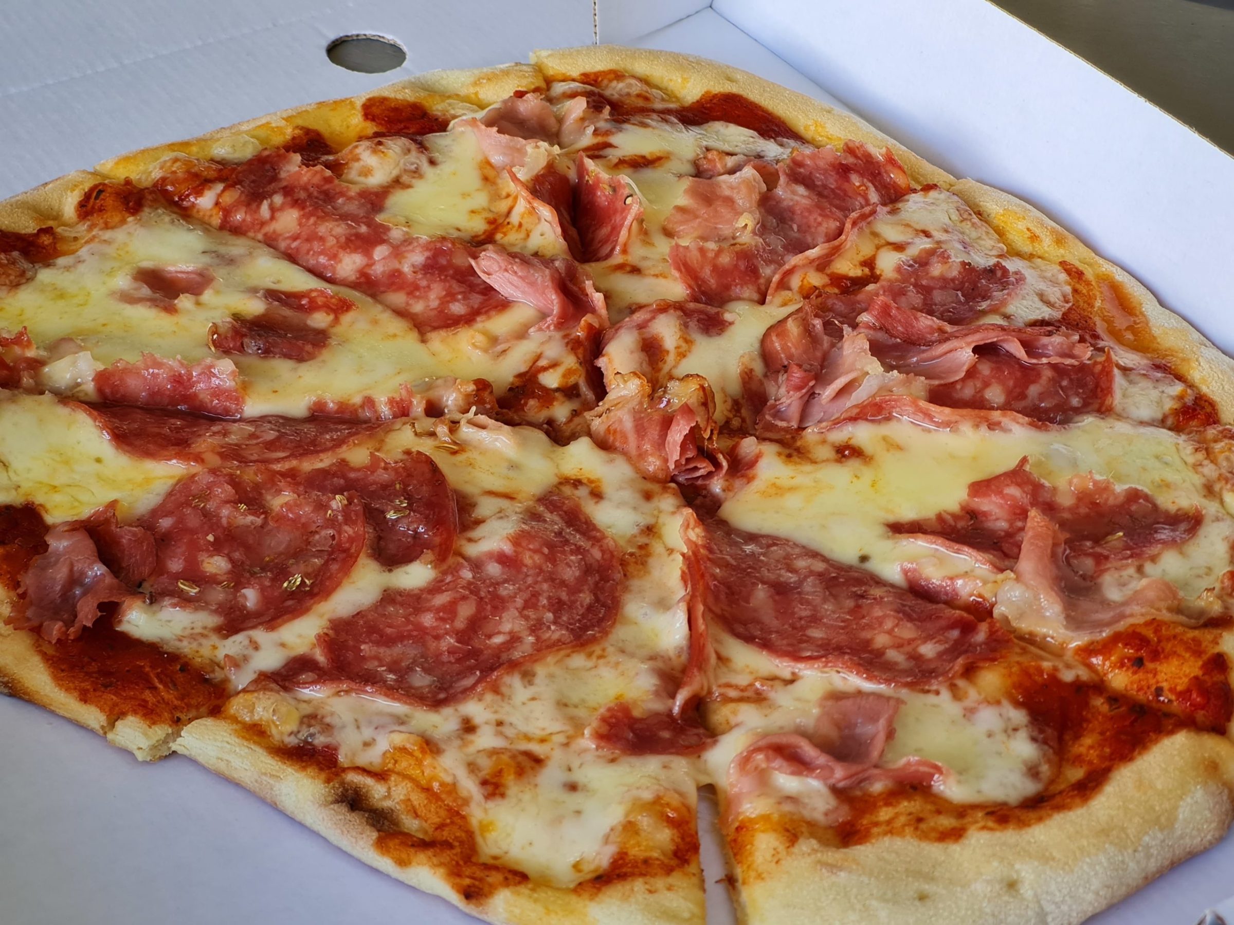 a close up of a slice of pepperoni pizza on a plate
