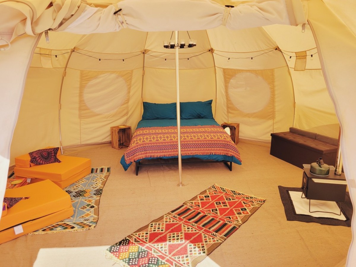 a bedroom with a bed and desk in a room