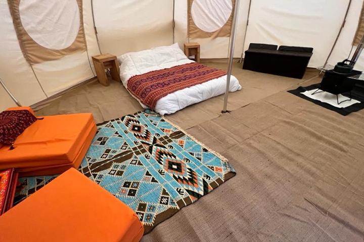 a bedroom with a bed and desk in a room