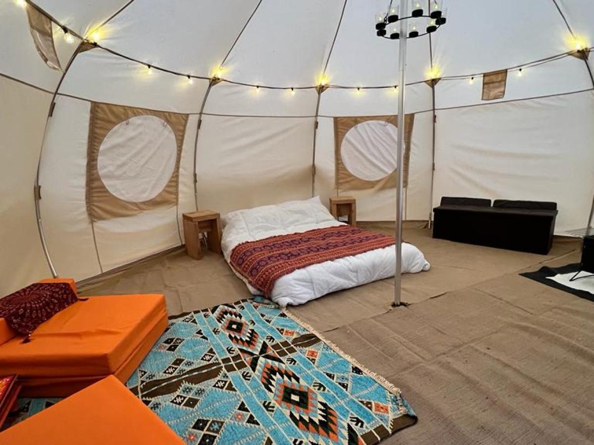 a bedroom with a bed and desk in a room