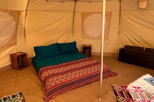 a bedroom with a bed and desk in a room