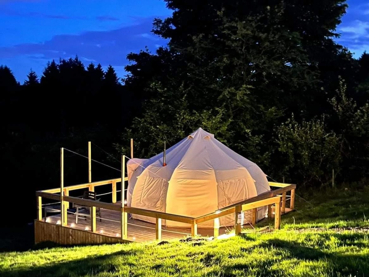 a person sitting on top of a grass covered field