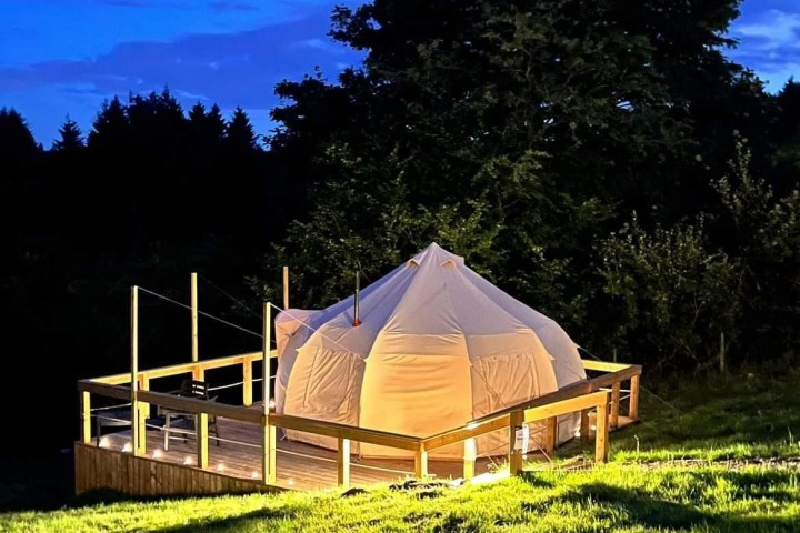 a person sitting on top of a grass covered field
