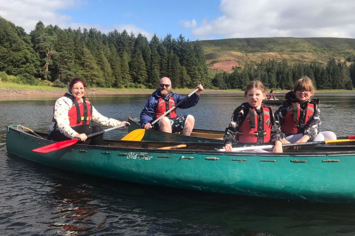 a group of people riding on the back of a boat in the water