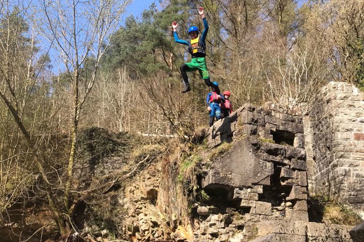 a man flying through the air over a body of water